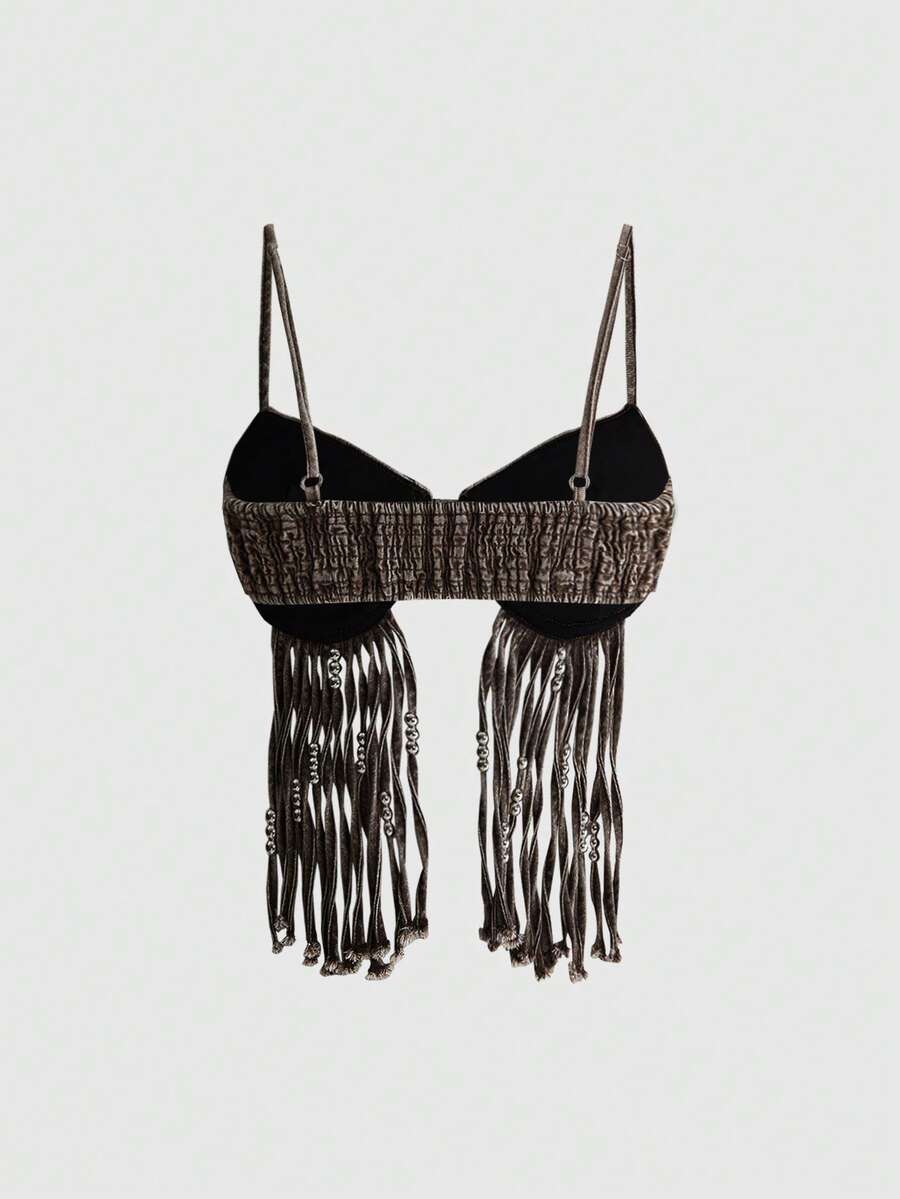 Blue denim camisole top for women featuring star patch detailing, fringe tassel asymmetrical hem, and spaghetti straps.