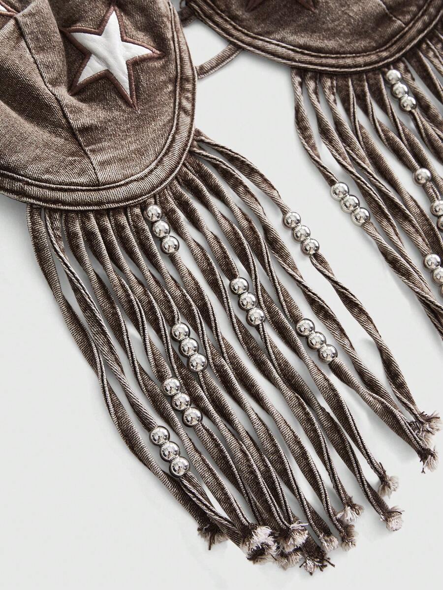 Blue denim camisole top for women featuring star patch detailing, fringe tassel asymmetrical hem, and spaghetti straps.