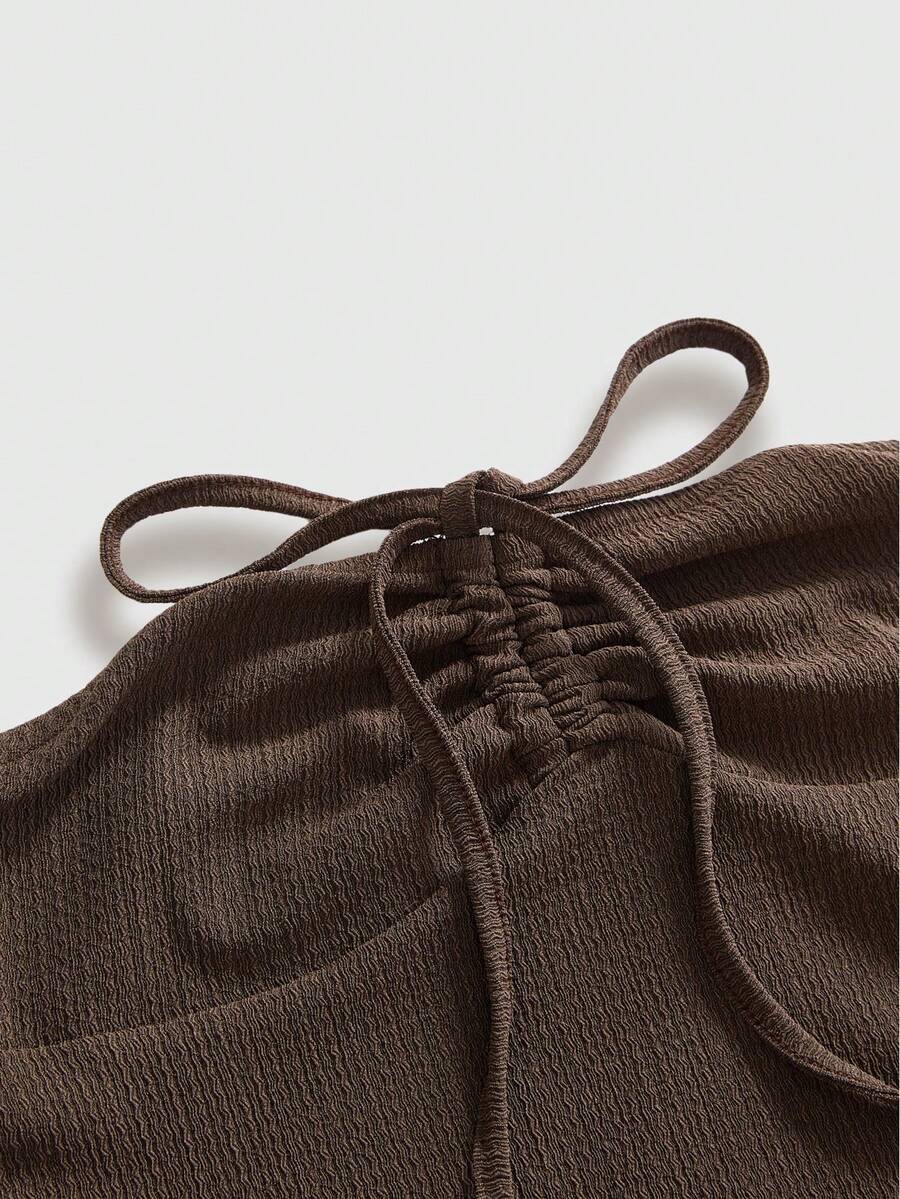Women's brown spaghetti strap cami mini dress featuring a slim fit bodycon silhouette with an asymmetrical knot ruffle hem.