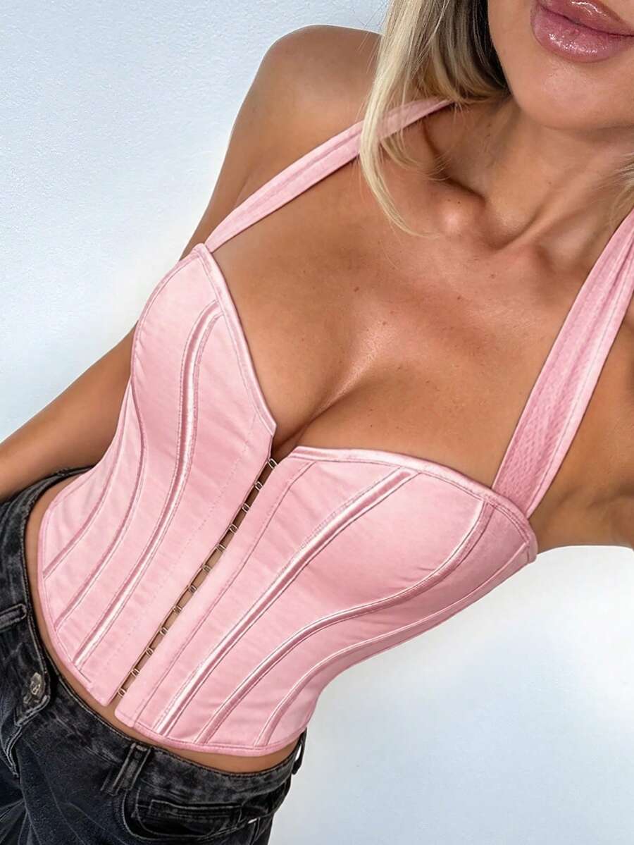 White Y2K halter backless corset top featuring lace-up back detail and metal grommet eyelets for women