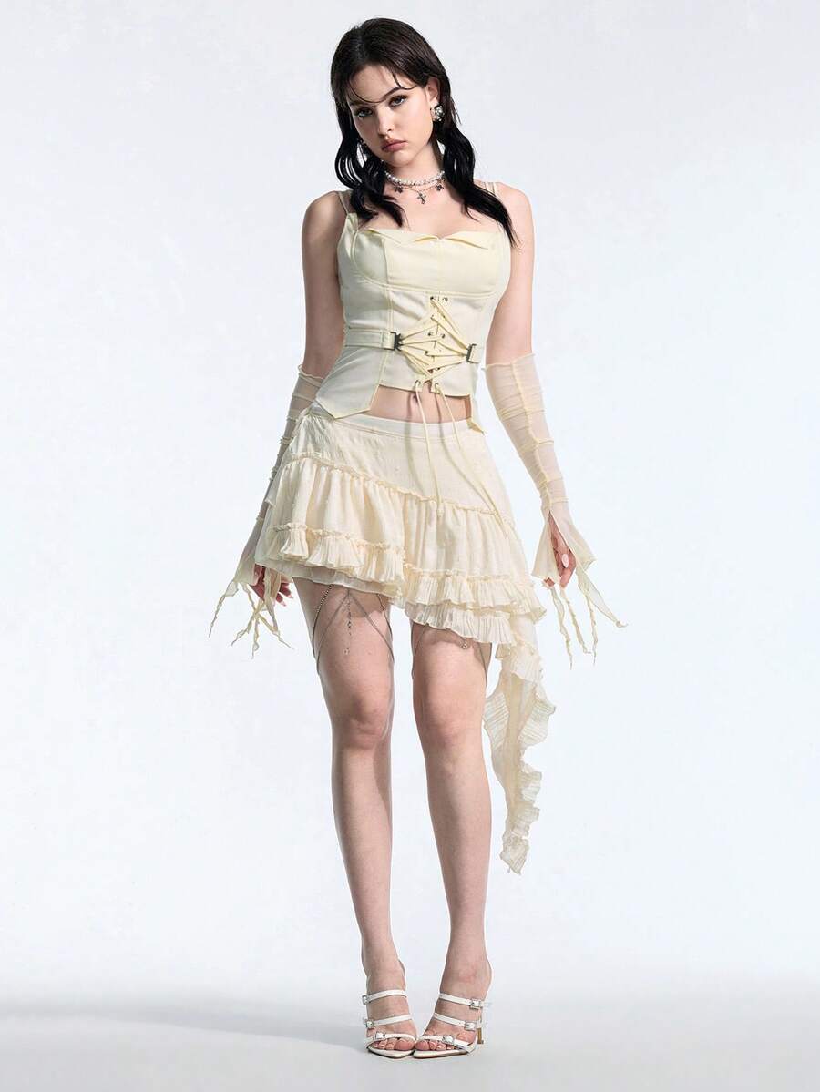 White lace-up crop camisole top for women featuring grommet eyelet details, a sweetheart neckline, shirred back, and asymmetrical hem.