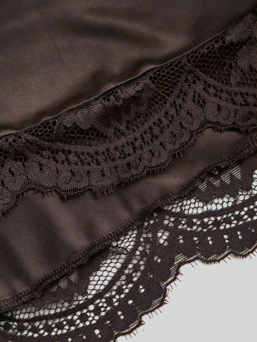 Women's black strapless lace patchwork bodycon mini dress featuring a slim fit design and an asymmetrical hem.
