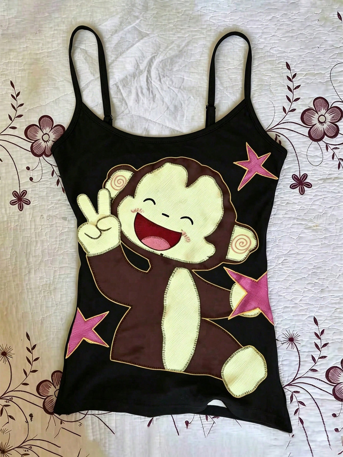 Burgundy cross pattern camisole top featuring spaghetti straps, ring accent, and a backless slim fit design.