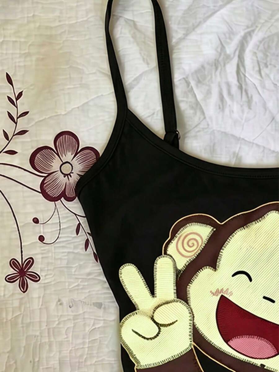 Burgundy cross pattern camisole top featuring spaghetti straps, ring accent, and a backless slim fit design.