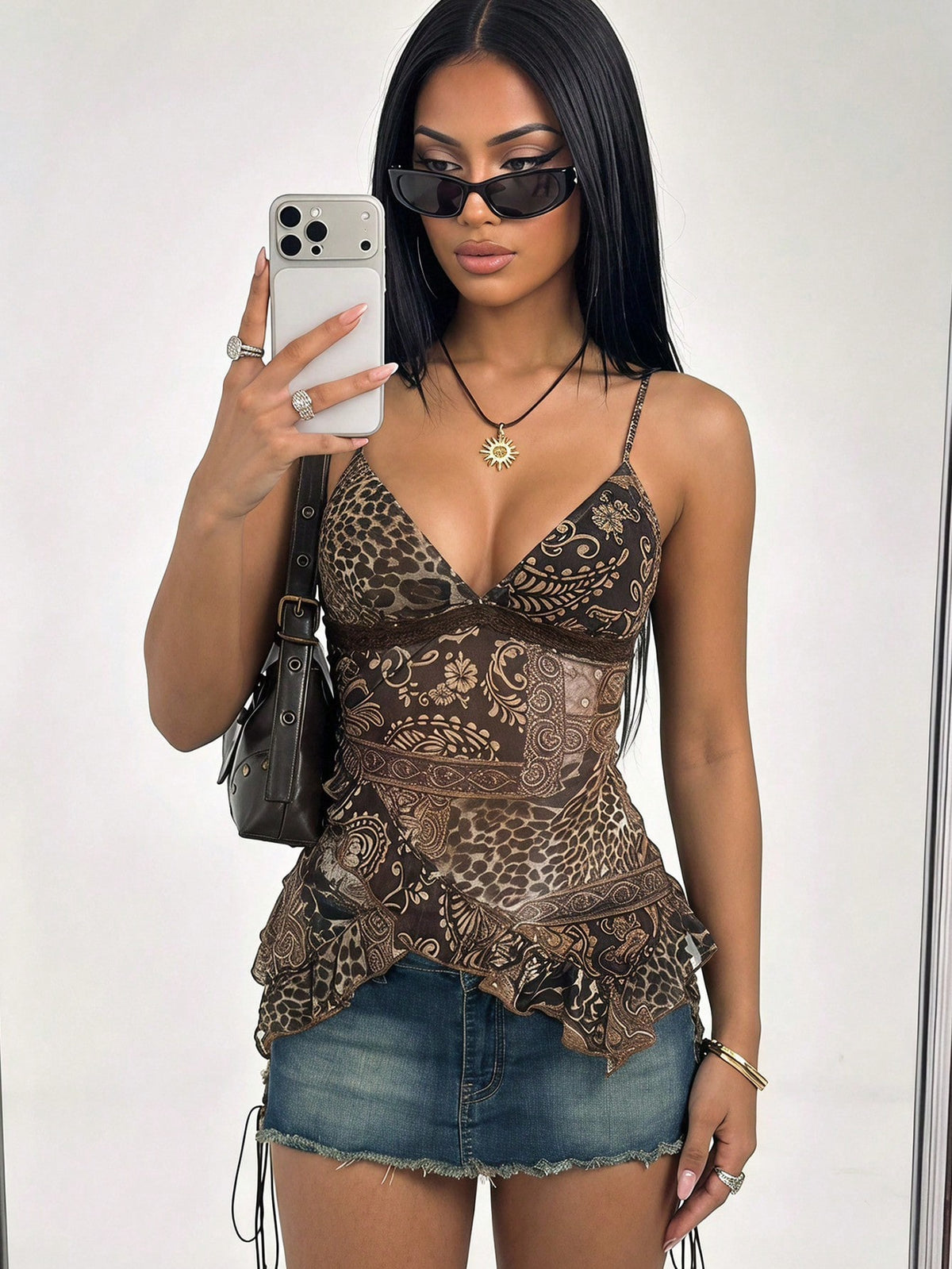 Women's burgundy floral graphic print mesh camisole top featuring an asymmetrical hem, backless cut, and spaghetti straps.