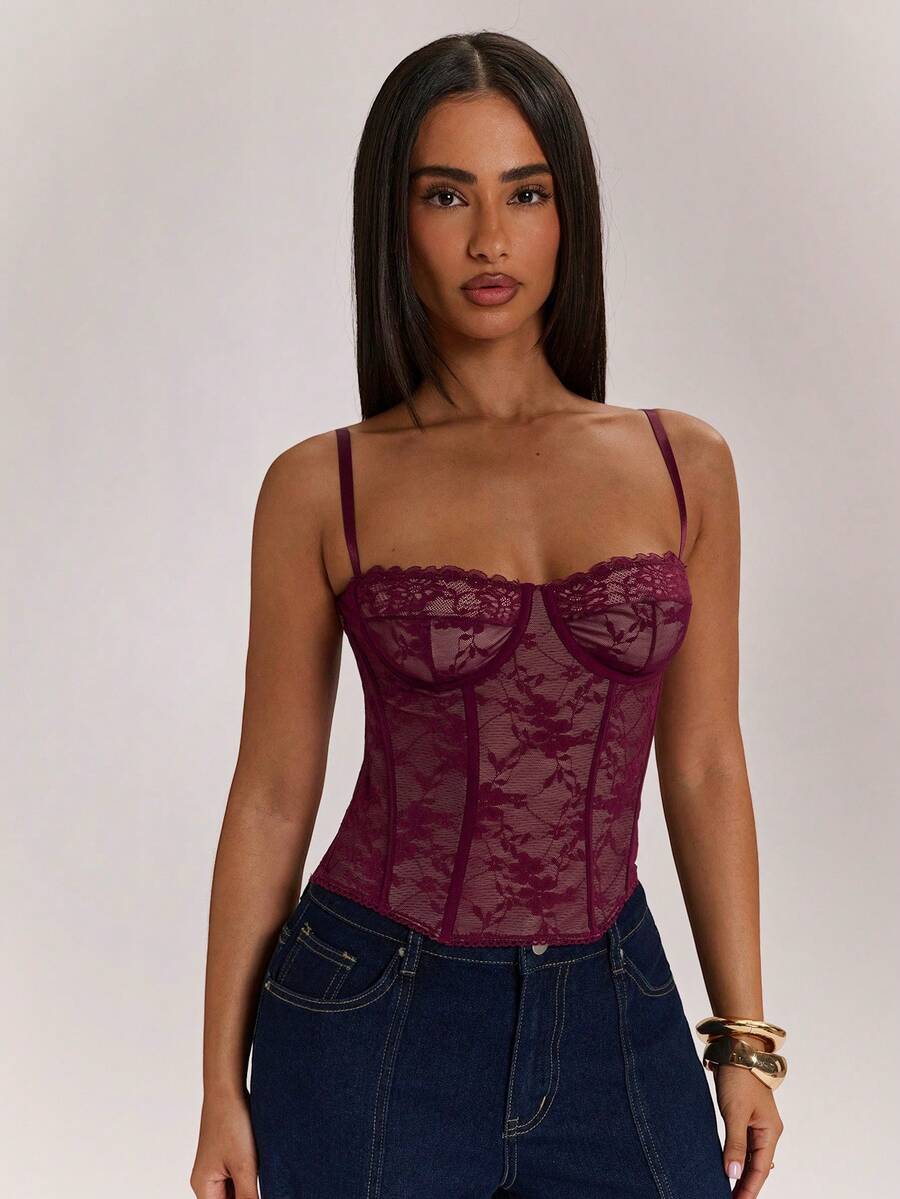 Black women’s lace cami top with spaghetti straps, contrast lace details, and an asymmetrical hem, styled as a slim-fit lined casual top.
