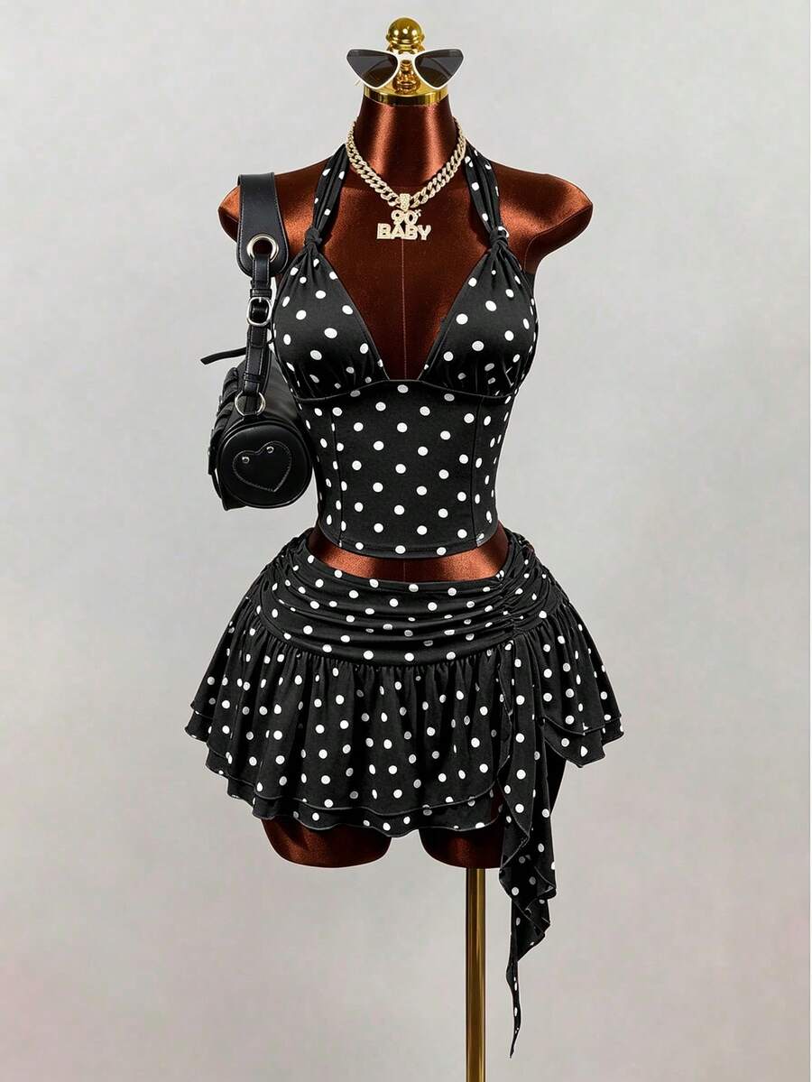 Women's black polka dot halter tank top featuring a backless design, knot detail, and slim fit.