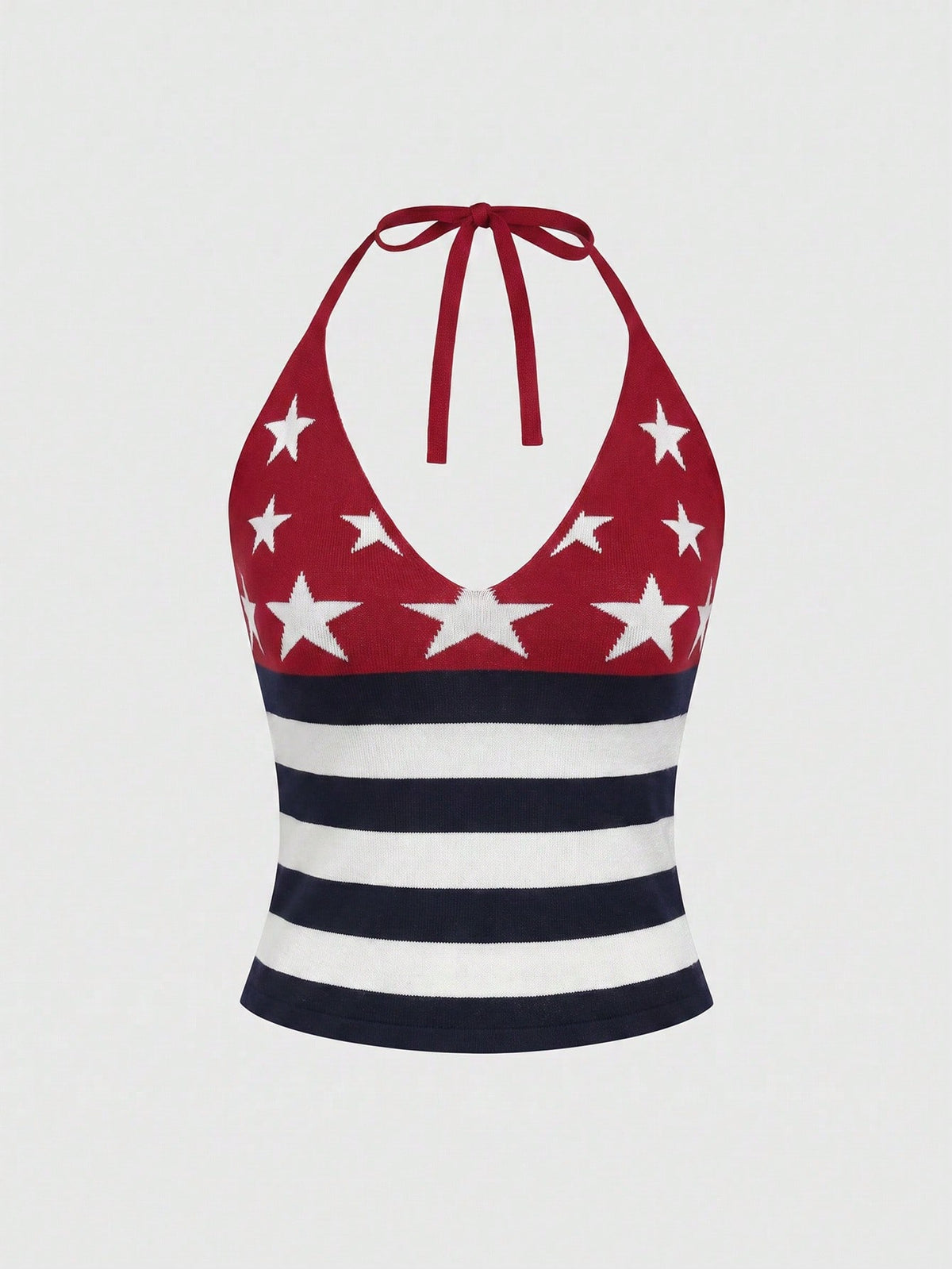 An apricot backless halter knit crop top featuring an American flag print, tied with a back knot, styled for Independence Day and casual fashion.