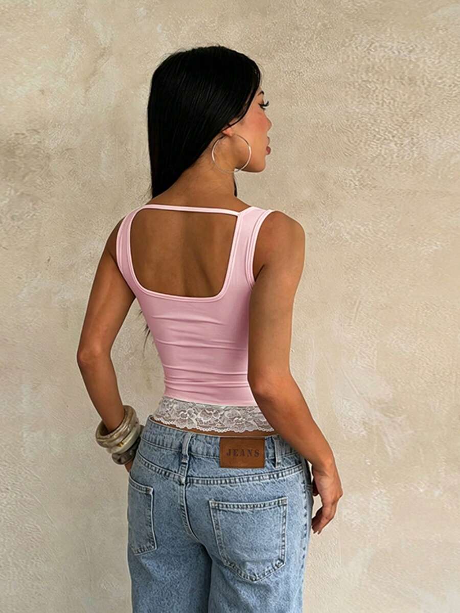 Women's white sleeveless crop top with contrast lace trim, shoulder straps, and a floral graphic print.