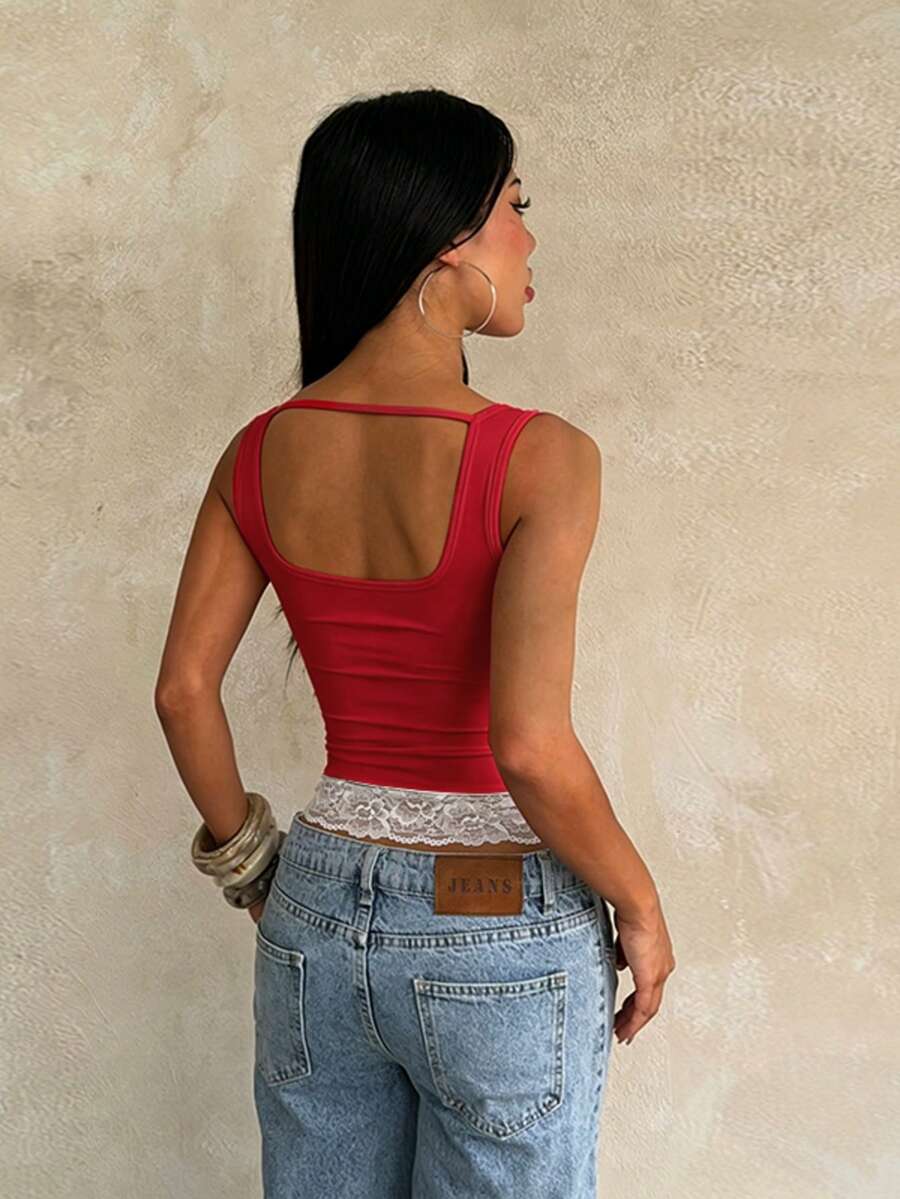 Women's white sleeveless crop top with contrast lace trim, shoulder straps, and a floral graphic print.