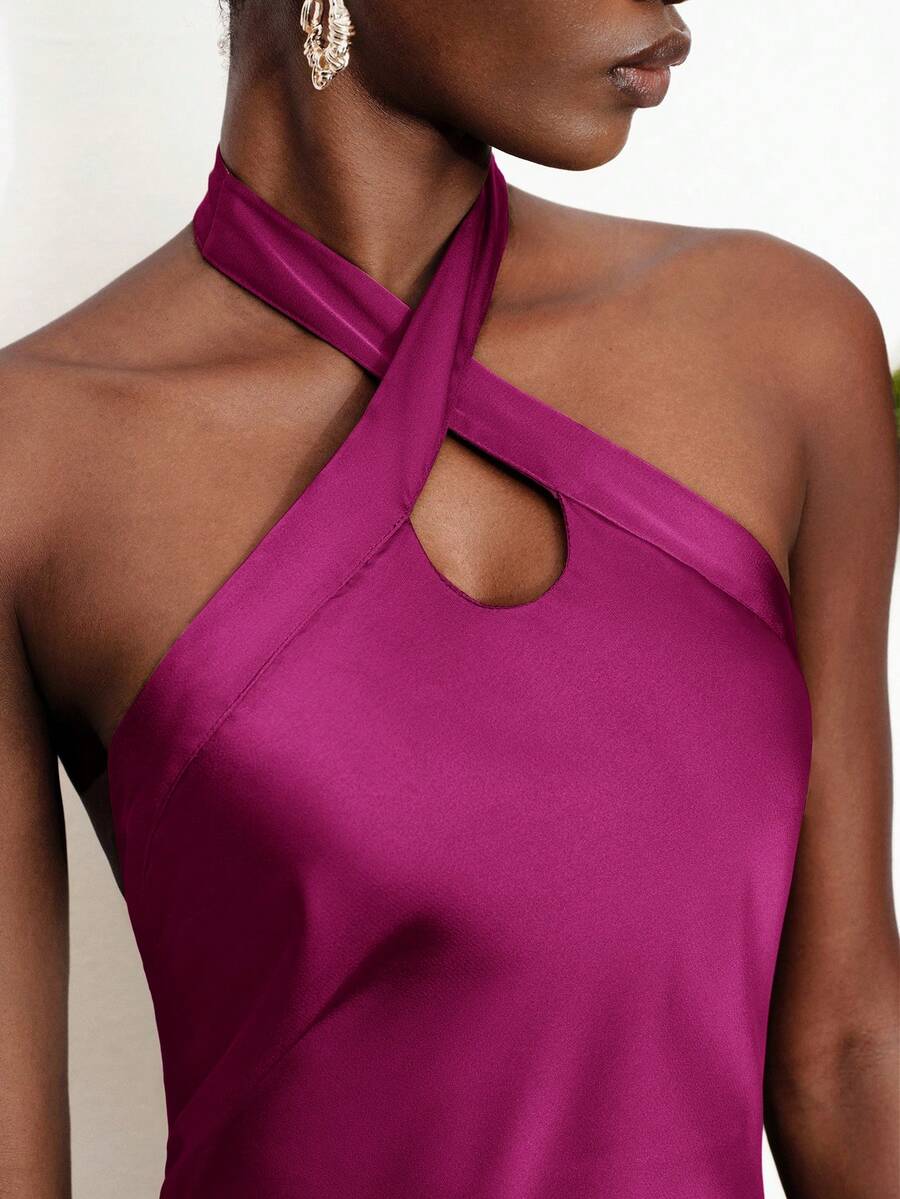 Women's black satin halter neck bodycon midi dress featuring a sleeveless backless design with front slit hem and wrap details.