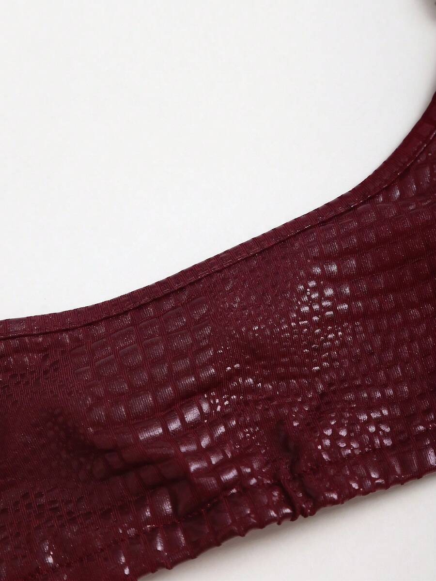 Women's black cropped camisole top with faux crocodile texture, backless spaghetti straps, and matching arm sleeves.