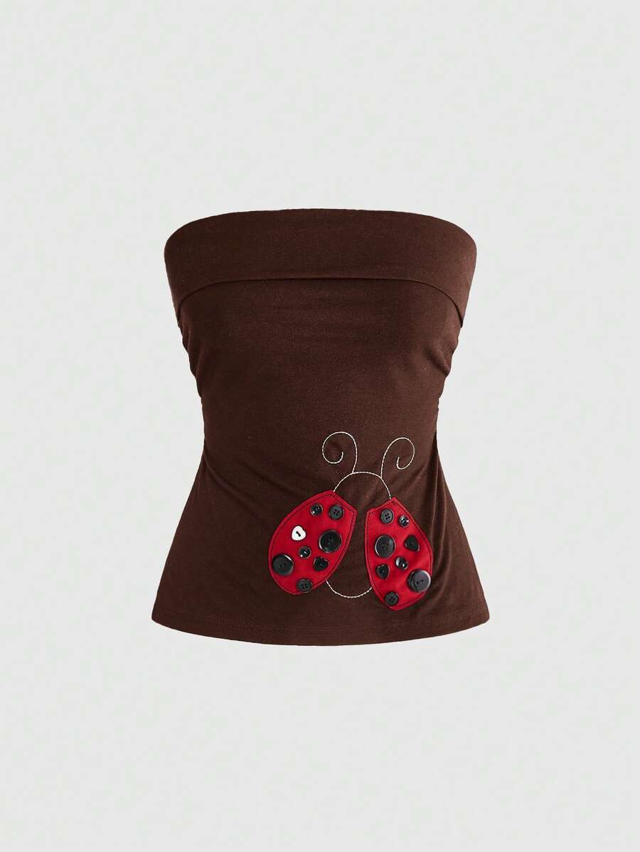 Women's black cropped strapless camisole top with ladybug embroidery and rhinestone details.