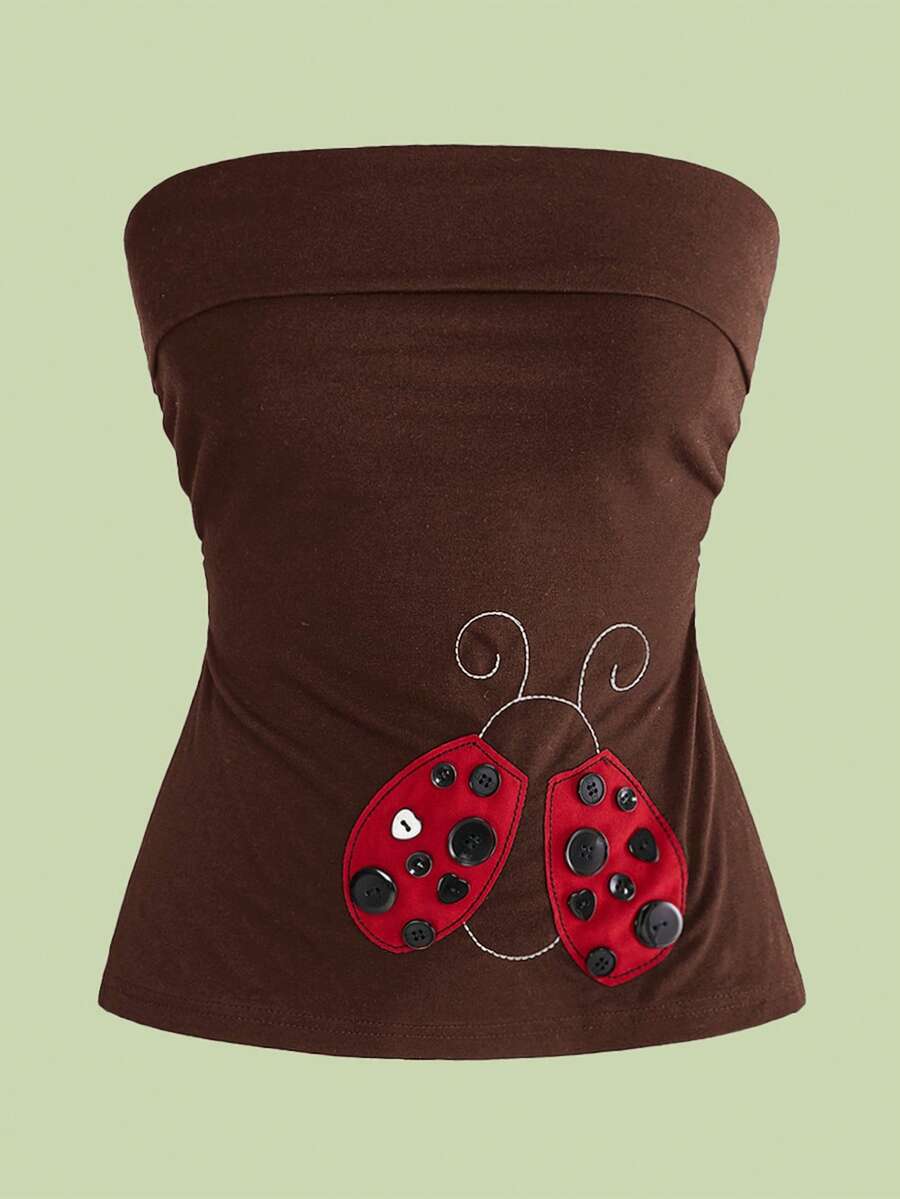 Women's black cropped strapless camisole top with ladybug embroidery and rhinestone details.