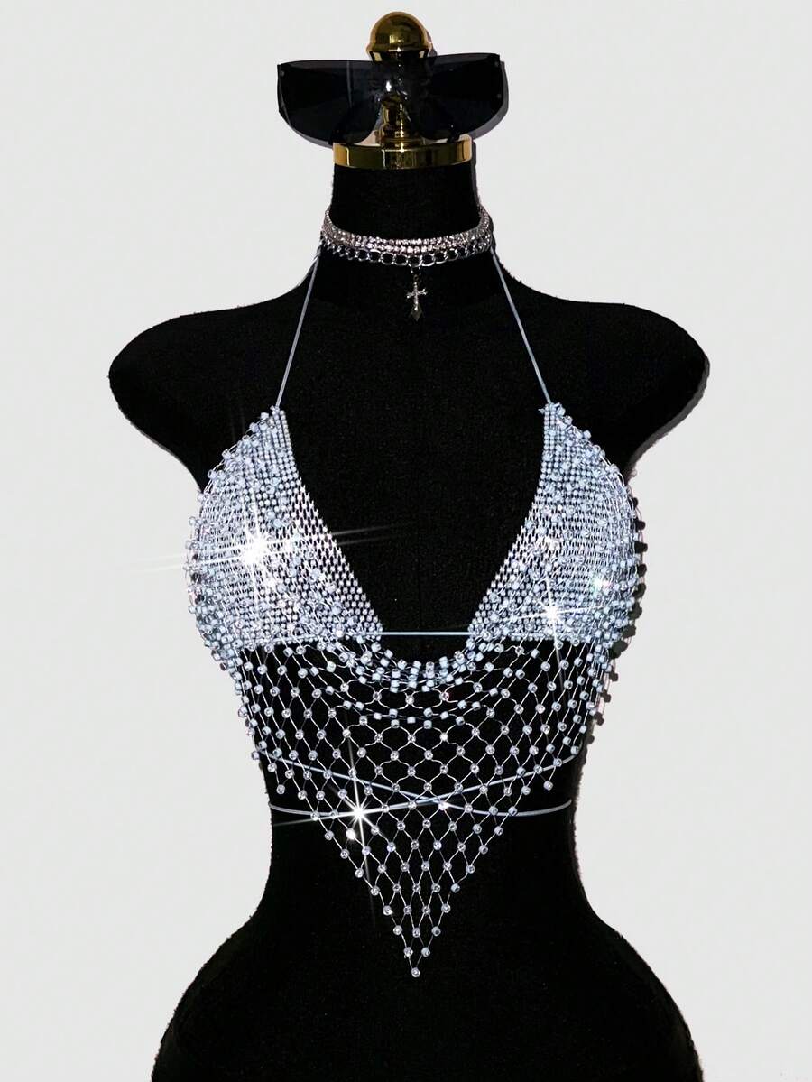 Black sheer mesh halter top for women featuring rhinestone glitter effect, backless design, chain details, and an asymmetrical hem.