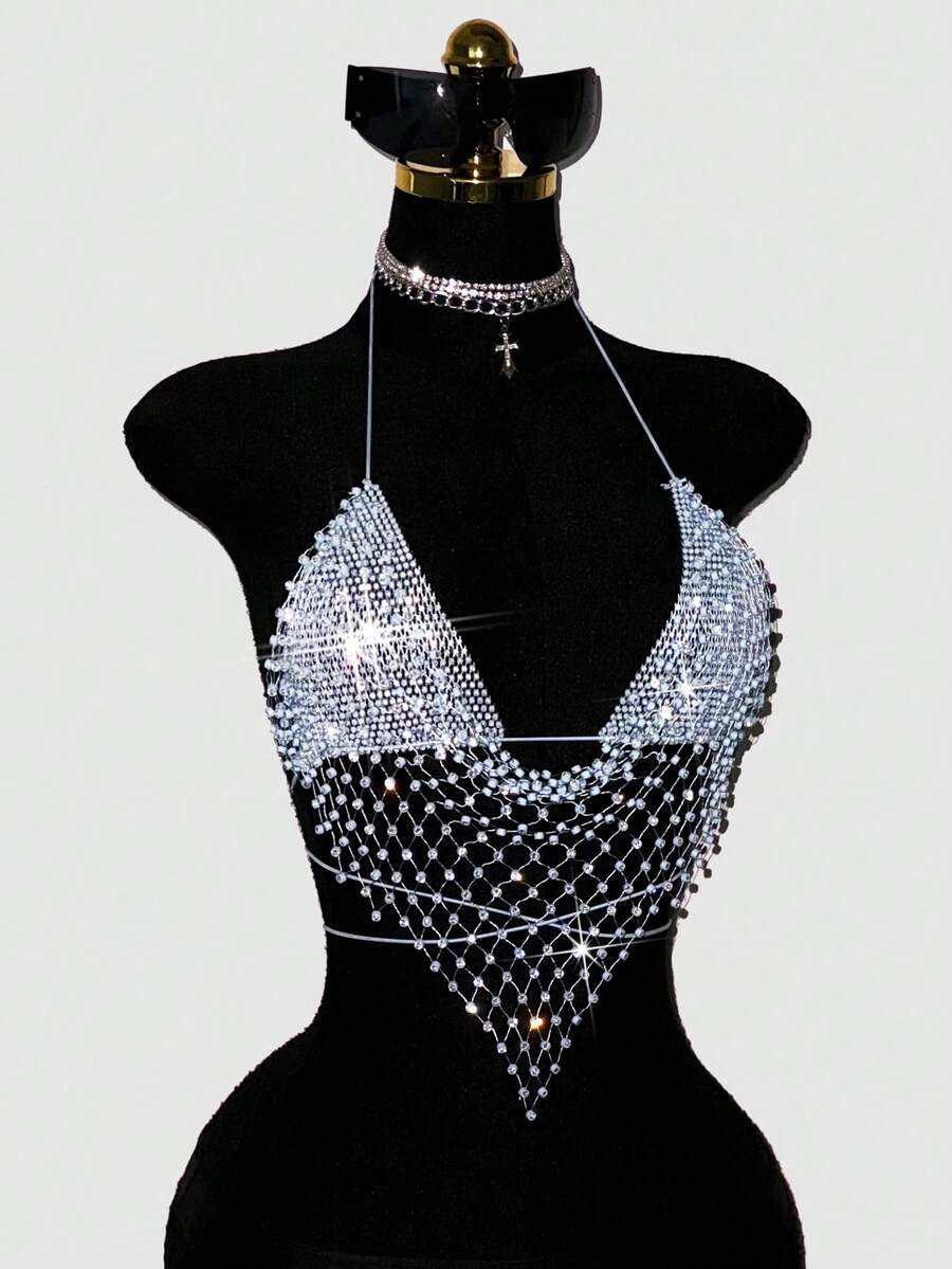 Black sheer mesh halter top for women featuring rhinestone glitter effect, backless design, chain details, and an asymmetrical hem.