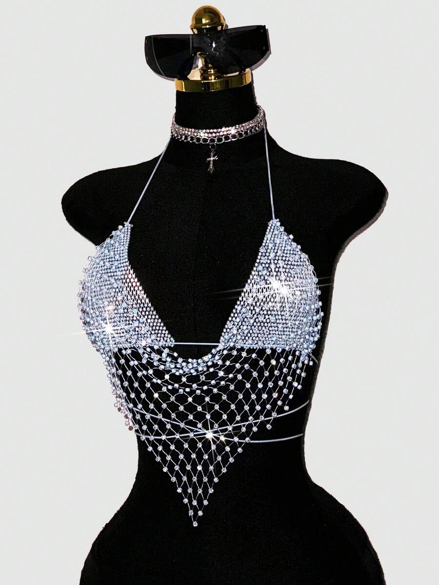 Black sheer mesh halter top for women featuring rhinestone glitter effect, backless design, chain details, and an asymmetrical hem.