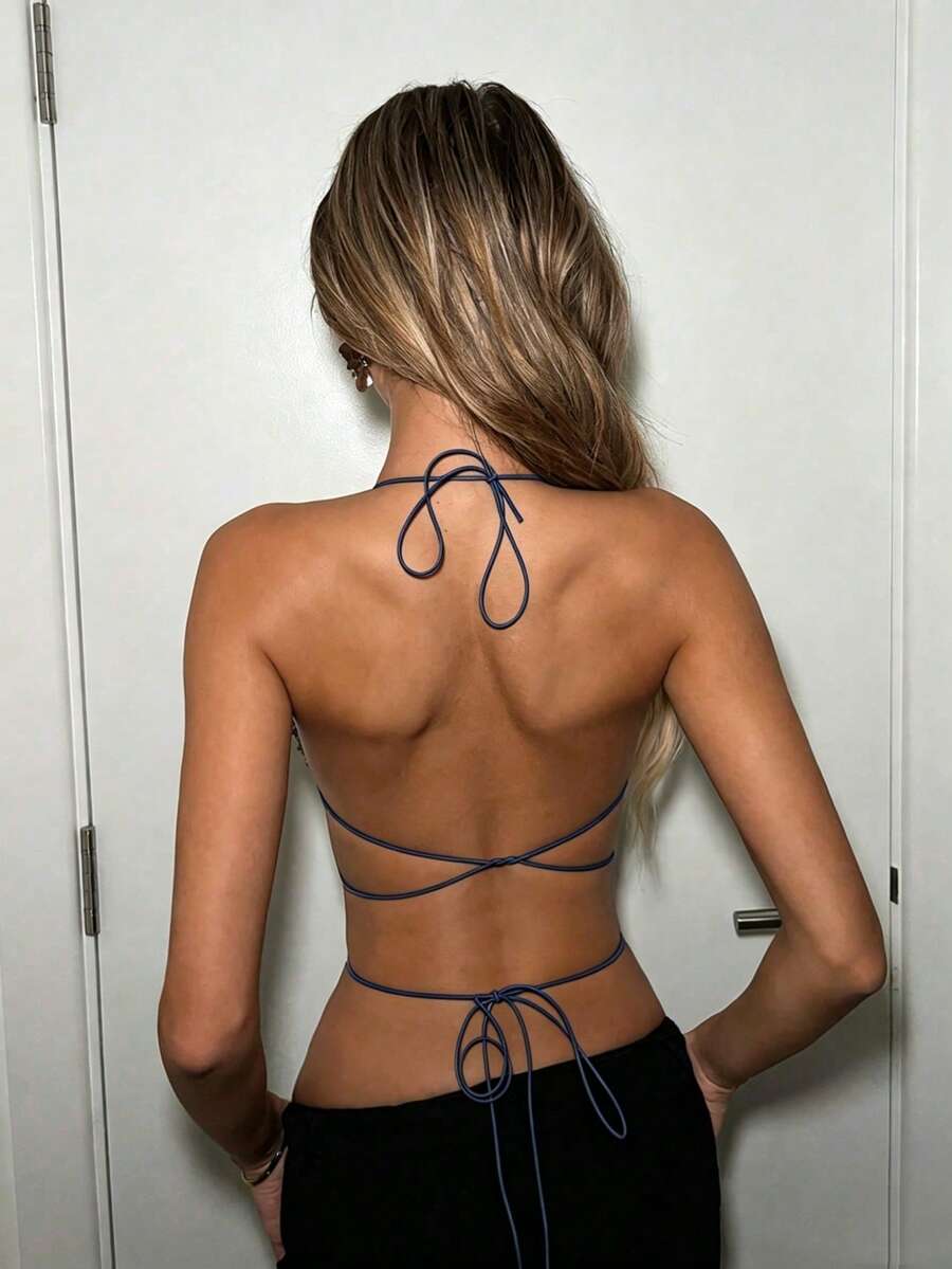 Black sheer mesh halter top for women featuring rhinestone glitter effect, backless design, chain details, and an asymmetrical hem.