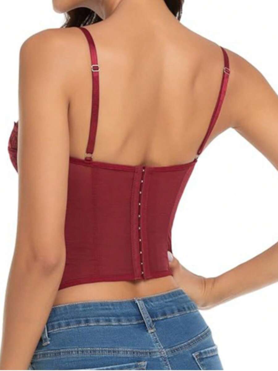 Black lace bustier corset top for women with buckle detail, spaghetti straps, slim fit, and lightweight mesh fabric for a night out look.