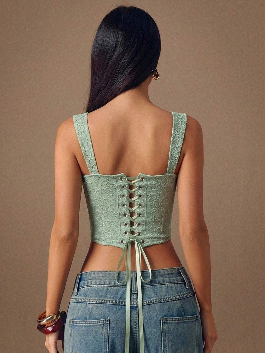 Women's slim fit tank top with rhinestone detail, wide straps, and a short length for casual beach wear.