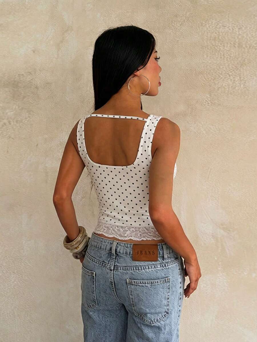 Women's white sleeveless crop top with contrast lace trim, shoulder straps, and a floral graphic print.