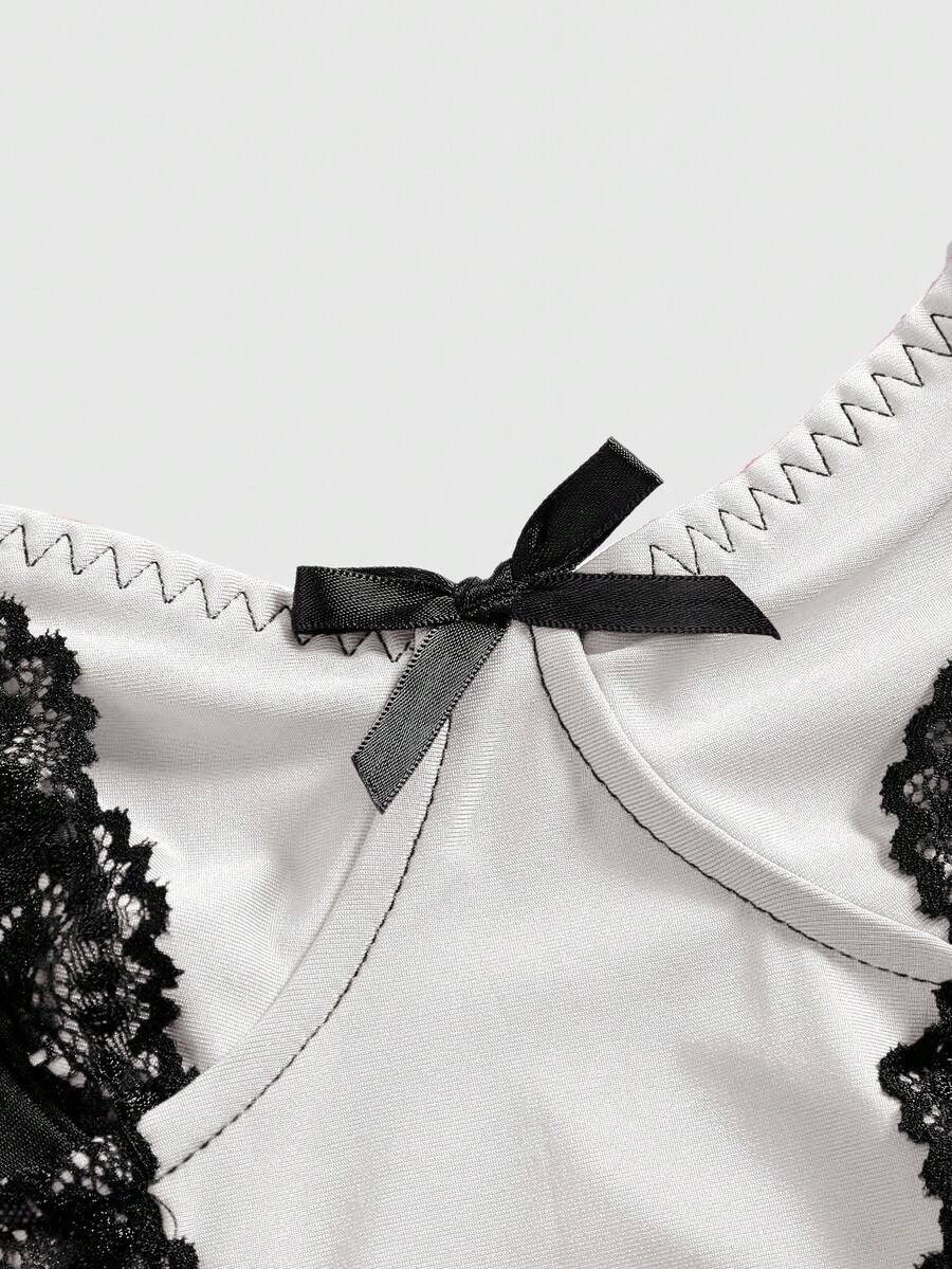 ROMWE women's black Goth Y2K contrast lace spaghetti strap cami crop top featuring bow details and waist tie decor.
