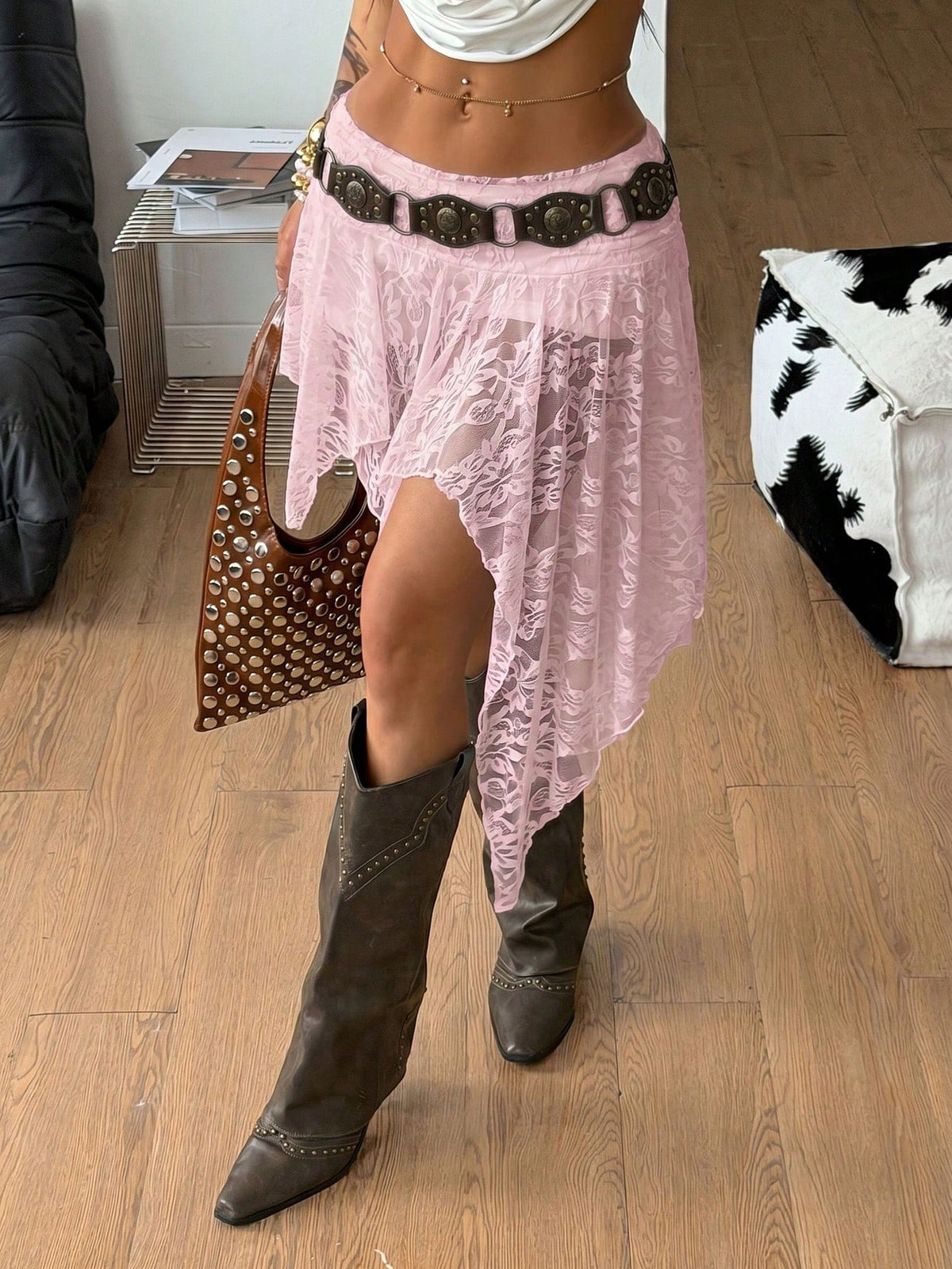 Women's asymmetrical ruffle skort with low waist, hollow out details, and lined body in knitted stretch fabric for beach and summer wear.
