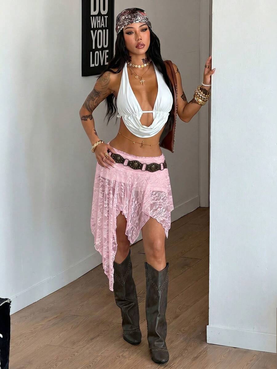 Women's asymmetrical ruffle skort with low waist, hollow out details, and lined body in knitted stretch fabric for beach and summer wear.