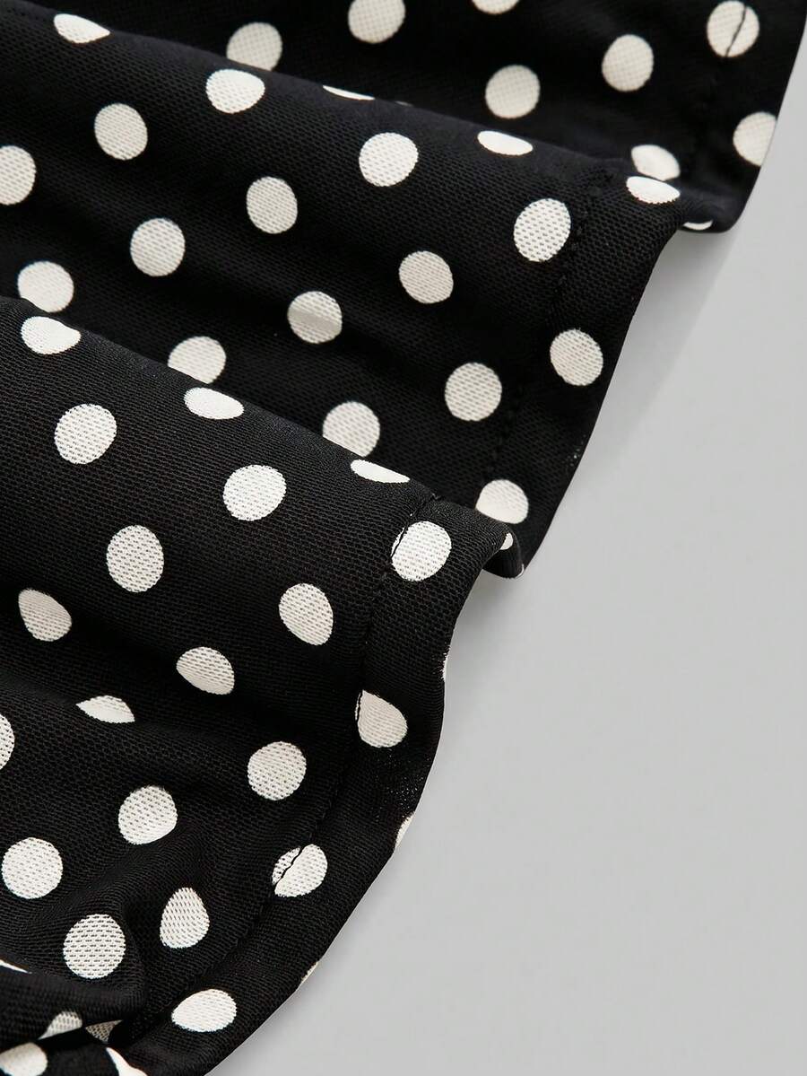 Women's black polka dot strapless tube top made of ruched mesh fabric featuring an asymmetrical hem and matching scarf.