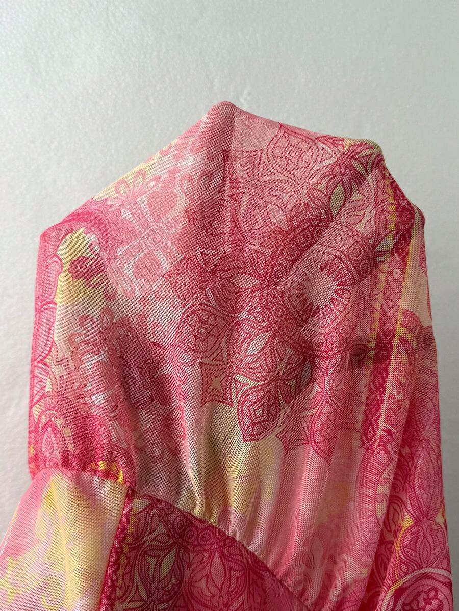 Baby pink low waist long skirt for women featuring a flared loose fit, split thigh detail, and textured random print fabric.