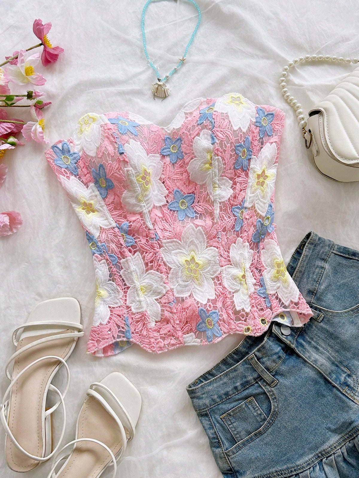 Strapless floral corset top with lace-up detail, asymmetrical hem, and slim fit for women in a boho vacation style.