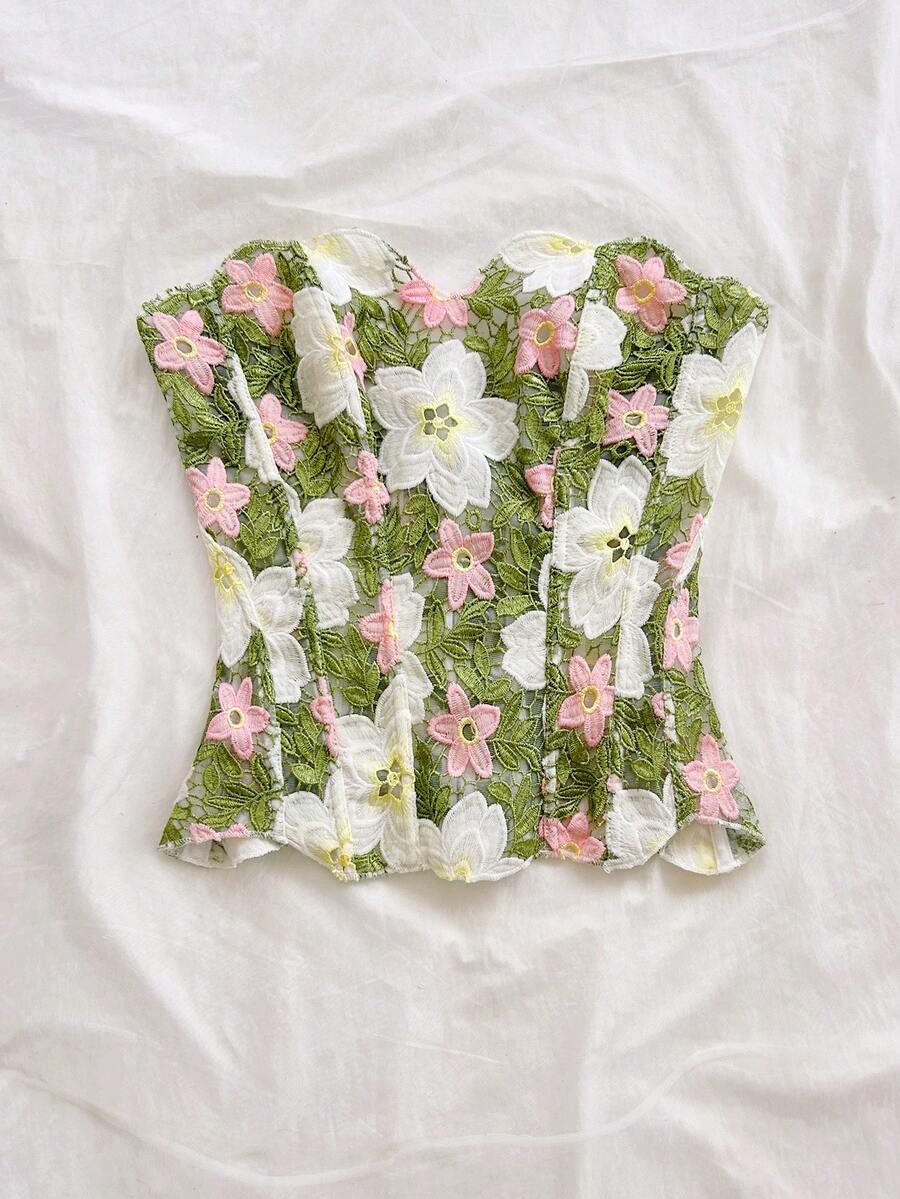 Strapless floral corset top with lace-up detail, asymmetrical hem, and slim fit for women in a boho vacation style.