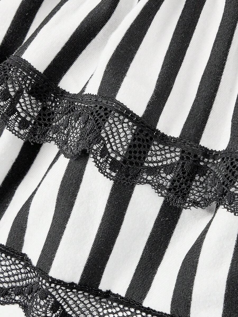 Women's black and white striped knit mini dress with spaghetti straps, slim fit silhouette, layered hem, and matching arm sleeves.