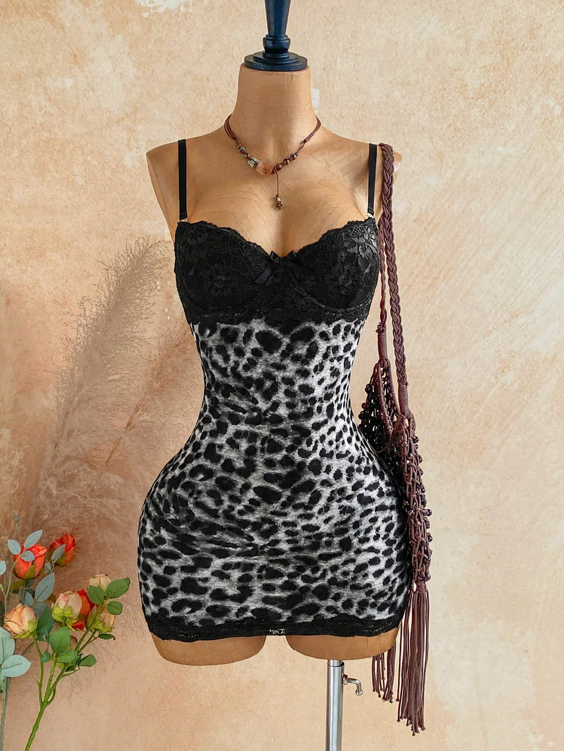Women's black mesh bodycon mini dress featuring spaghetti straps, contrast lace cup details, backless styling, and a slim fit.