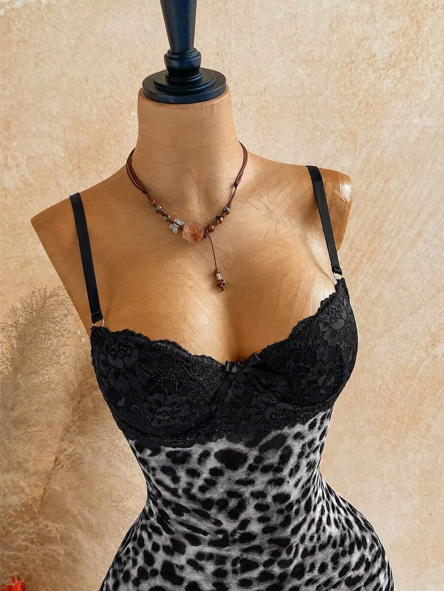 Women's black mesh bodycon mini dress featuring spaghetti straps, contrast lace cup details, backless styling, and a slim fit.