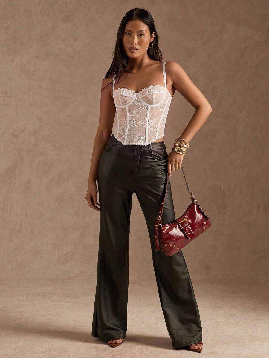 Black women’s lace cami top with spaghetti straps, contrast lace details, and an asymmetrical hem, styled as a slim-fit lined casual top.