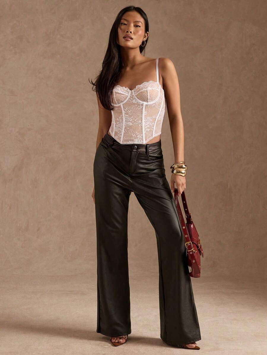 Black women’s lace cami top with spaghetti straps, contrast lace details, and an asymmetrical hem, styled as a slim-fit lined casual top.