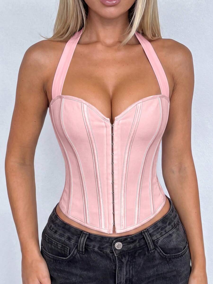 White Y2K halter backless corset top featuring lace-up back detail and metal grommet eyelets for women