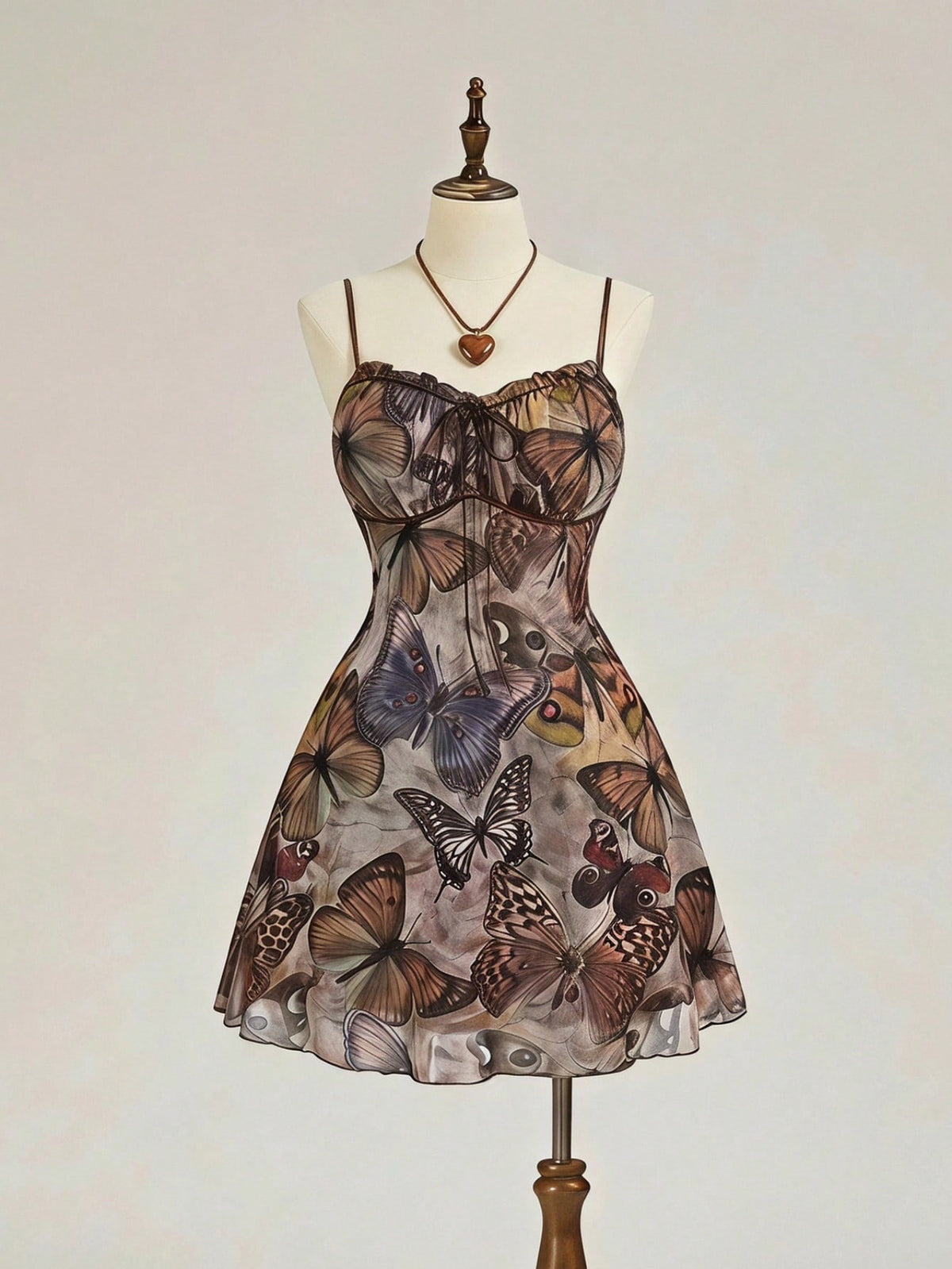 Women's brown boho cami mini dress featuring a graphic butterfly print, spaghetti straps, high waist flared hem, and matching arm sleeves in high-stretch mesh fabric.