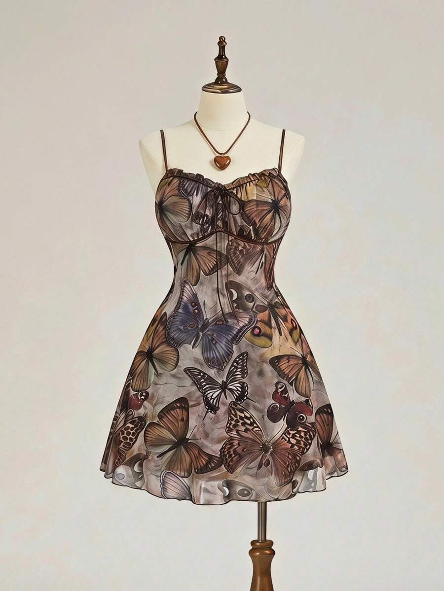 Women's brown boho cami mini dress featuring a graphic butterfly print, spaghetti straps, high waist flared hem, and matching arm sleeves in high-stretch mesh fabric.