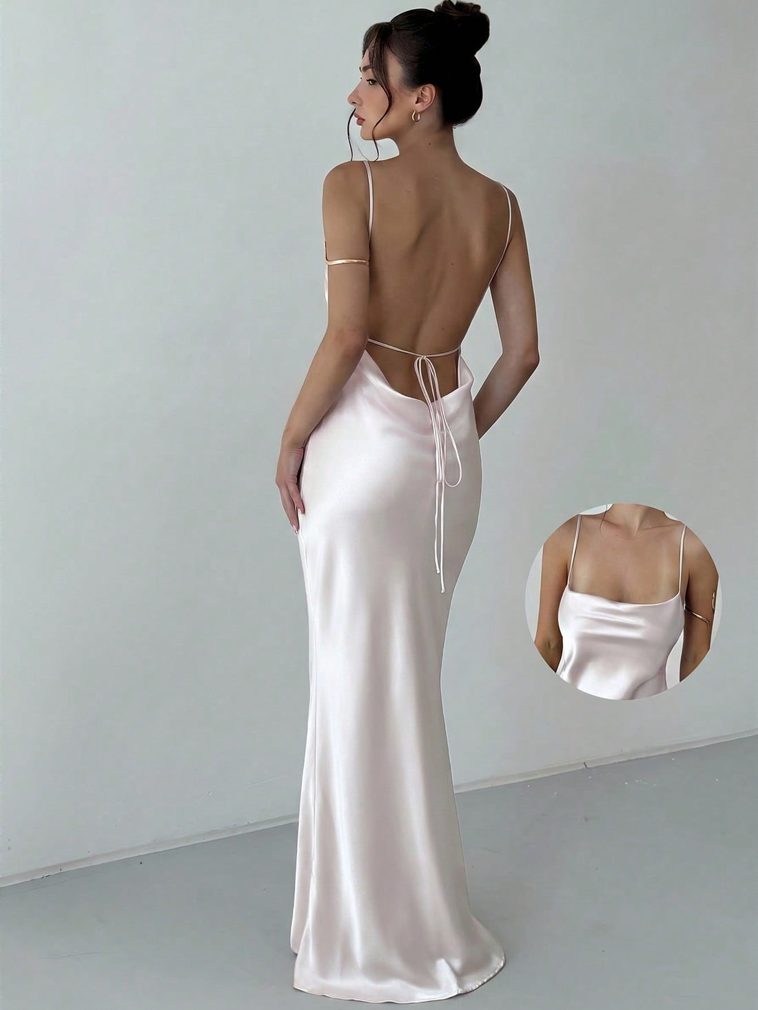 Beige satin backless maxi dress featuring criss-cross spaghetti straps and a mermaid hemline.