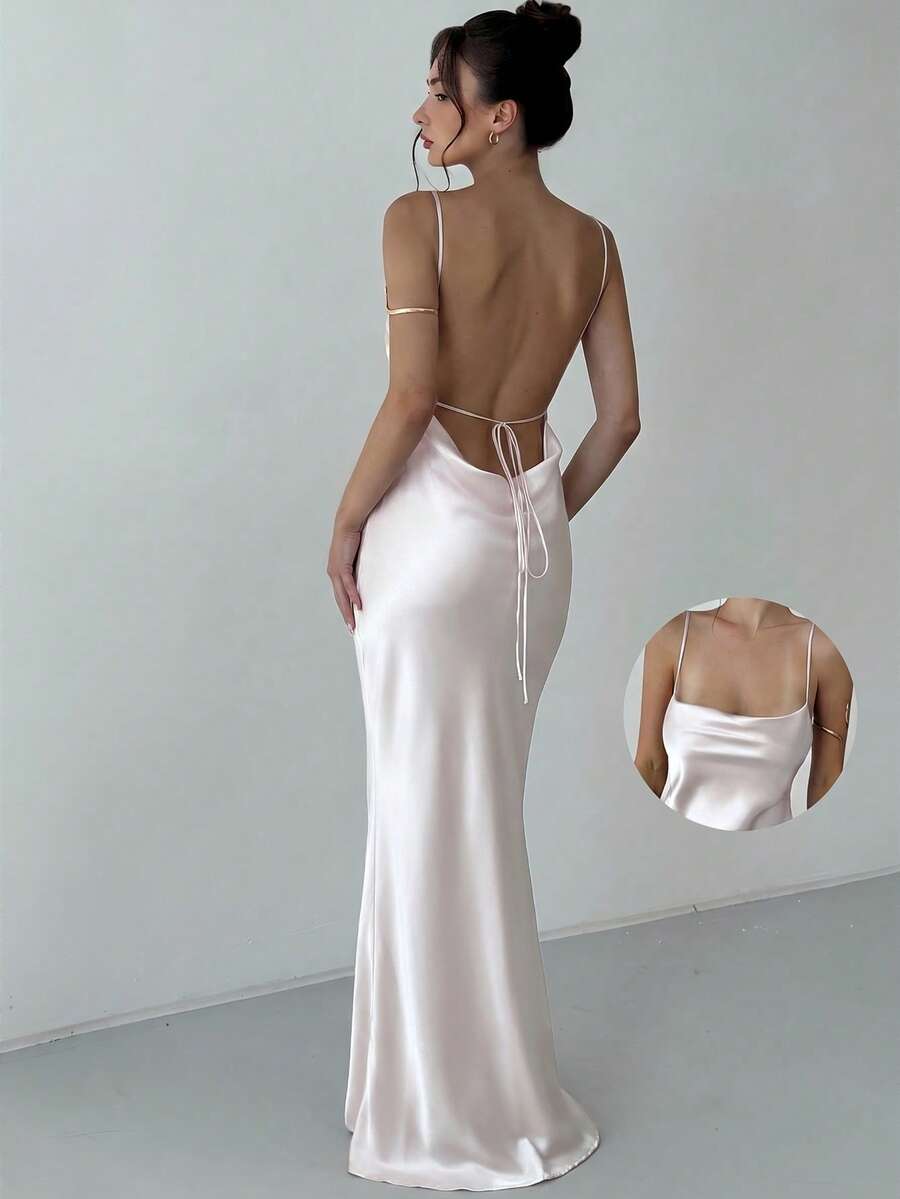 Beige satin backless maxi dress featuring criss-cross spaghetti straps and a mermaid hemline.