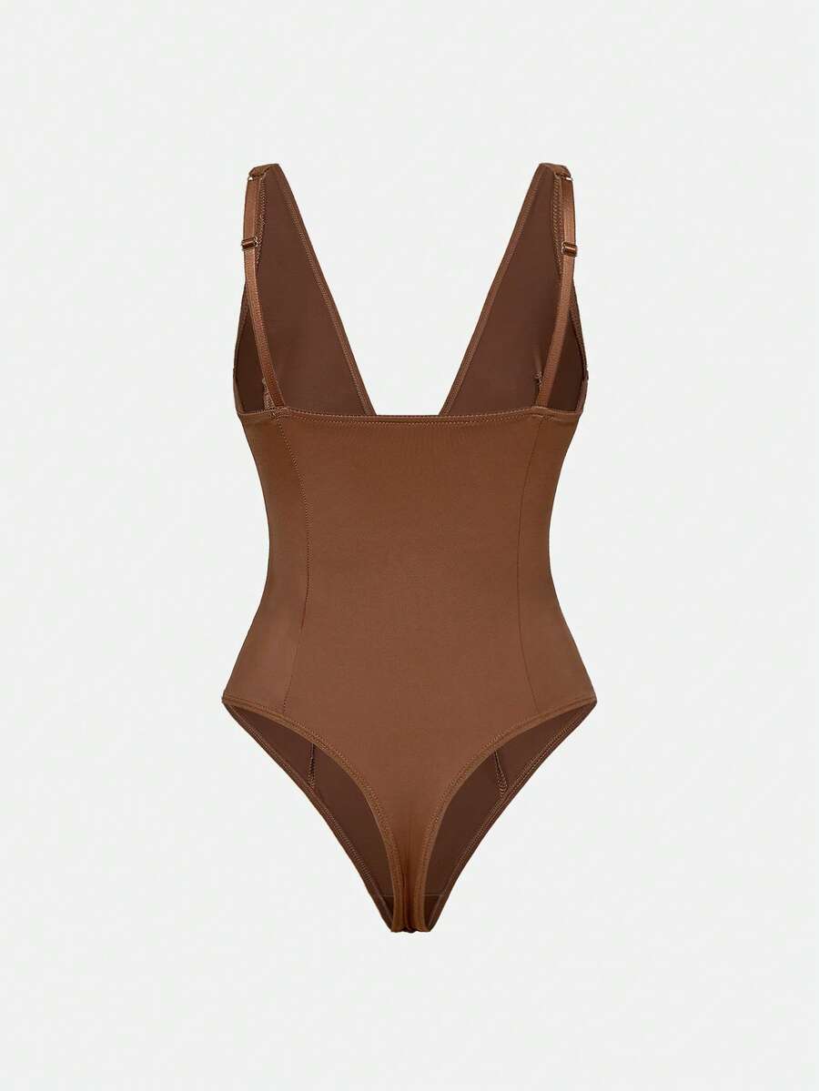 Apricot backless shapewear bodysuit with thong cut, cup details, and high-stretch fabric for light tummy support.