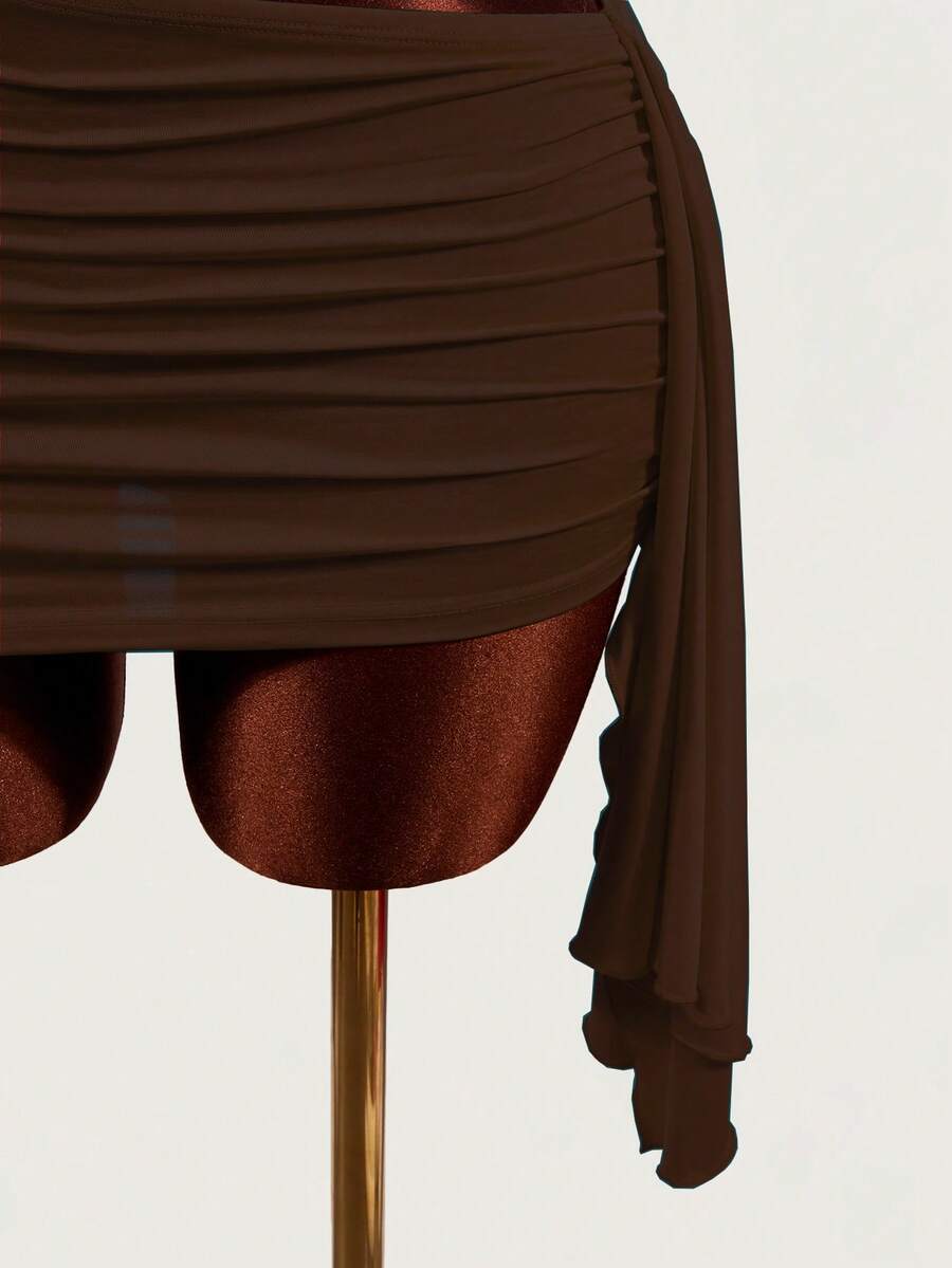 Women's black halter hollow out mini bodycon dress featuring backless asymmetrical knot details and a slim pencil fit.
