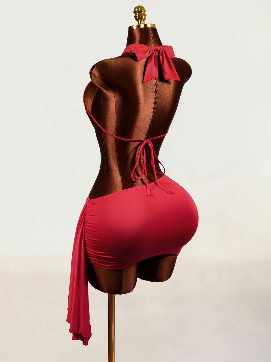 Women's black halter hollow out mini bodycon dress featuring backless asymmetrical knot details and a slim pencil fit.