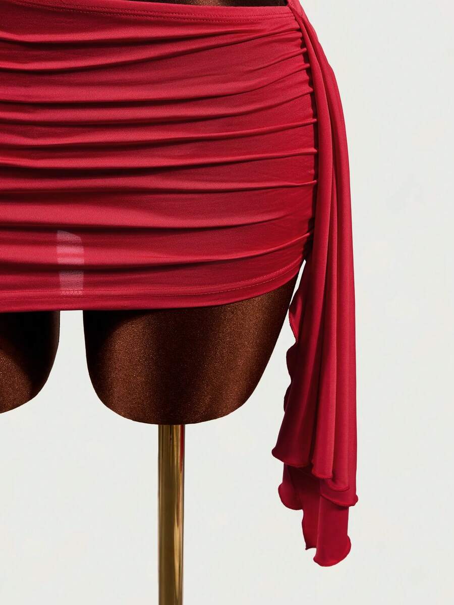 Women's black halter hollow out mini bodycon dress featuring backless asymmetrical knot details and a slim pencil fit.