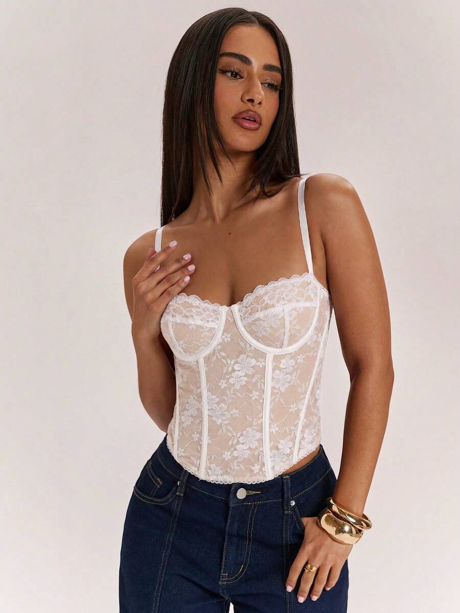 Black women’s lace cami top with spaghetti straps, contrast lace details, and an asymmetrical hem, styled as a slim-fit lined casual top.