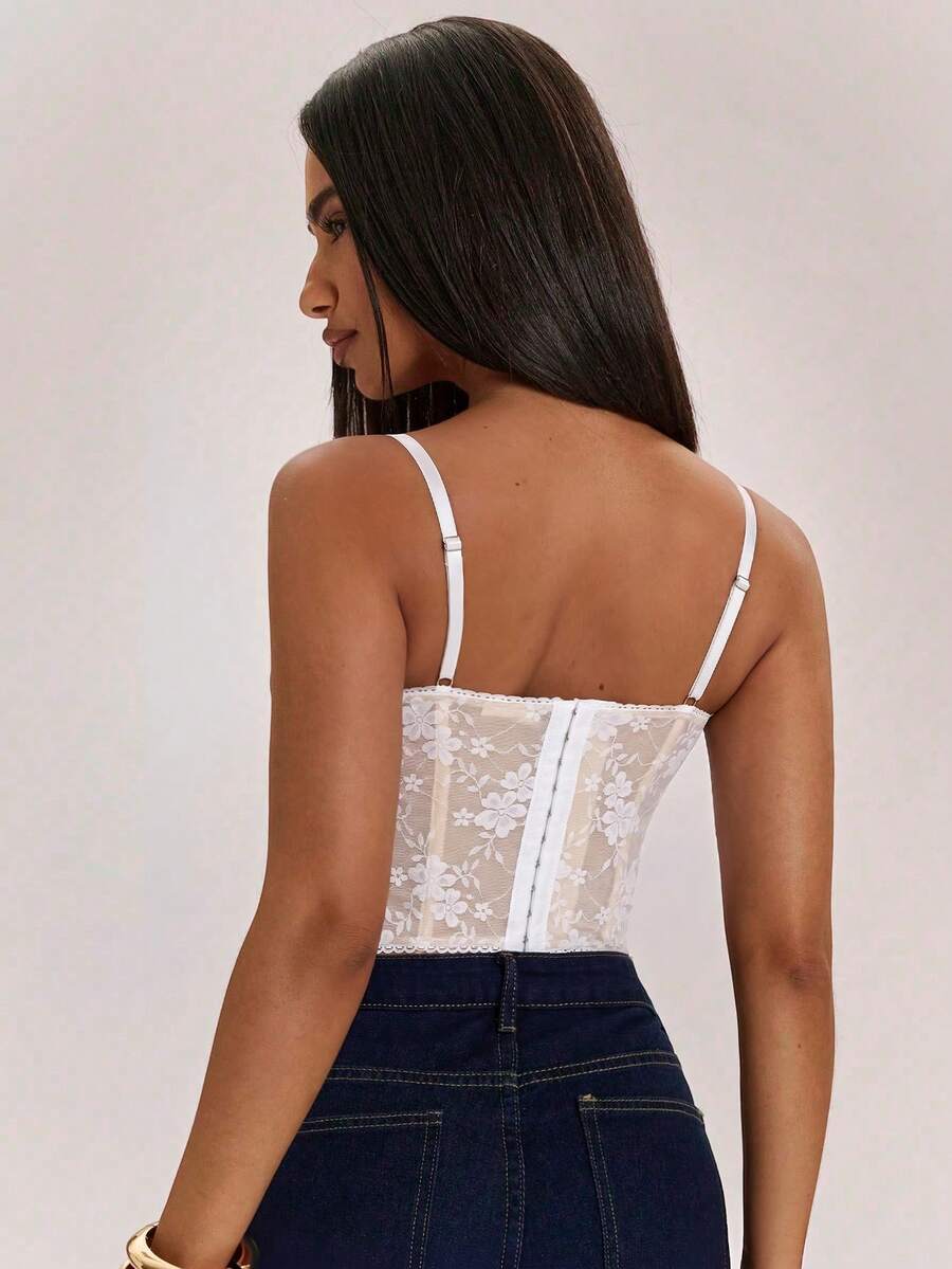 Women’s camisole top with cup detail, spaghetti straps, lined body, and slim fit design in knitted fabric with an asymmetrical hem.