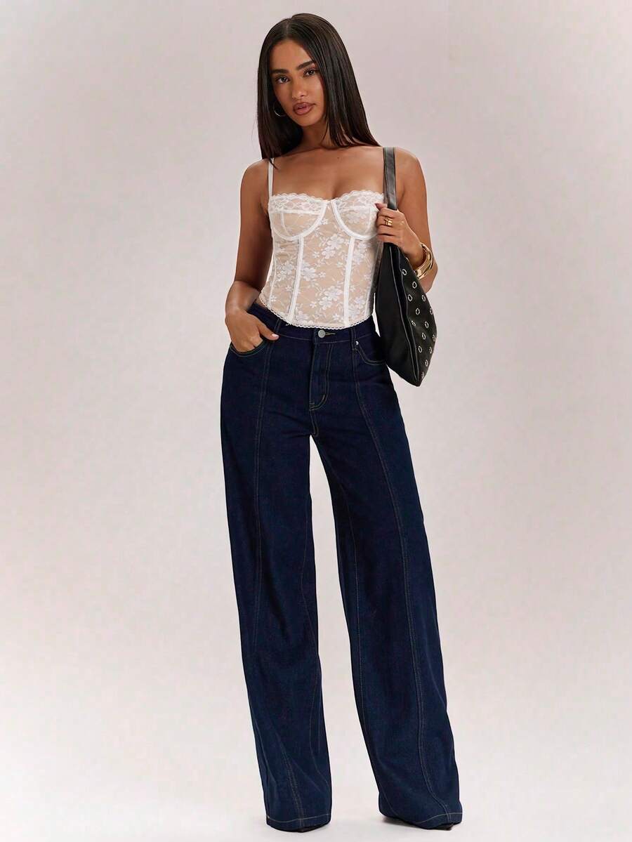 Women’s camisole top with cup detail, spaghetti straps, lined body, and slim fit design in knitted fabric with an asymmetrical hem.