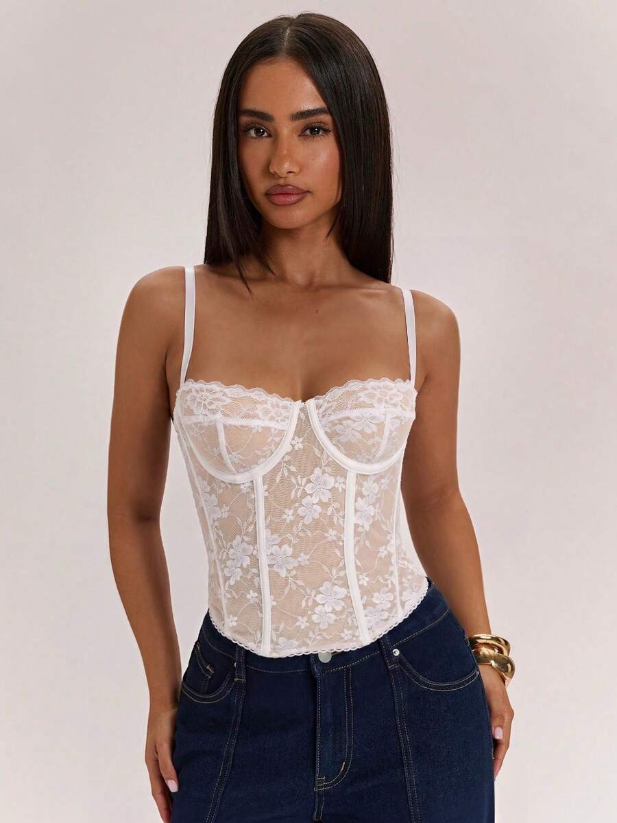 Women’s camisole top with cup detail, spaghetti straps, lined body, and slim fit design in knitted fabric with an asymmetrical hem.
